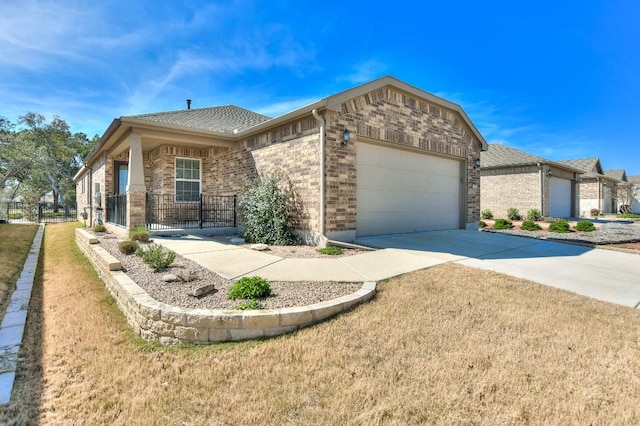 220 Comal Ln, Georgetown, TX 78633 - single story home with an attached garage, brick siding, driveway, a front lawn, and roof with shingles