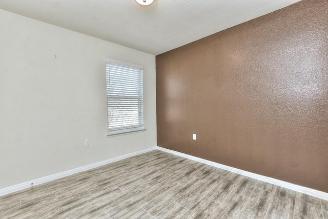 unfurnished room with light hardwood / wood-style floors