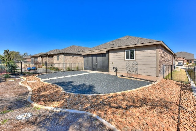 220 Comal Ln, Georgetown, TX 78633 - back of property featuring a patio, a fenced backyard, and a sunroom