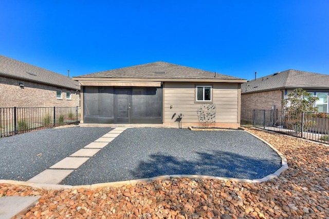 rear view of property with a patio and a sunroom