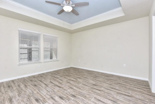 220 Comal Ln, Georgetown, TX 78633 - empty room featuring ornamental molding, wood finished floors, a ceiling fan, baseboards, and a tray ceiling