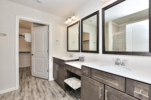 bathroom featuring vanity, hardwood / wood-style floors, and an enclosed shower