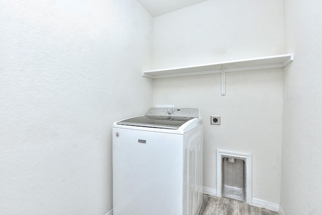 clothes washing area featuring washer / clothes dryer and hardwood / wood-style floors