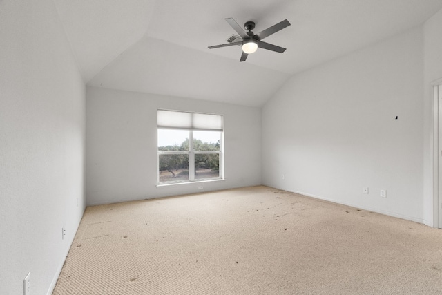 unfurnished room with vaulted ceiling, ceiling fan, and light colored carpet