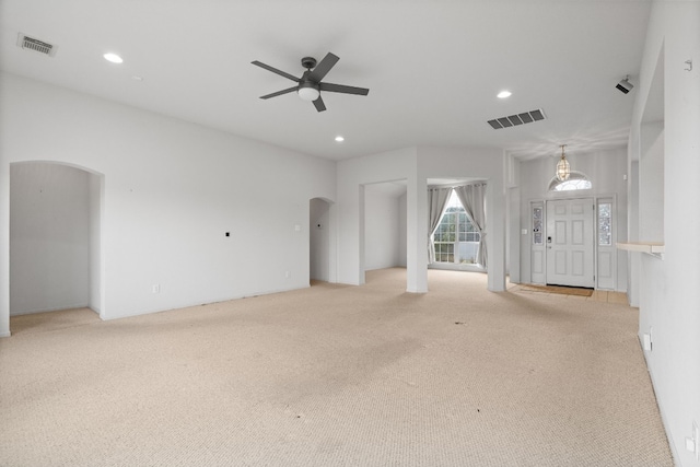 unfurnished living room with light carpet and ceiling fan