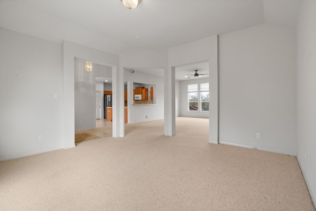 unfurnished room with carpet flooring and vaulted ceiling