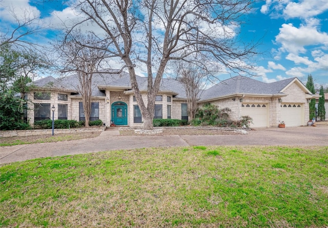 ranch-style home featuring a front yard and a garage