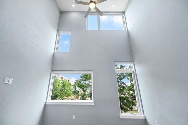 2002 E 7th St Unit 204, Austin, TX 78702 - unfurnished living room featuring a towering ceiling and a ceiling fan