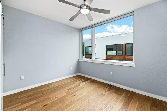 2002 E 7th St Unit 204, Austin, TX 78702 - empty room featuring wood finished floors, baseboards, and ceiling fan