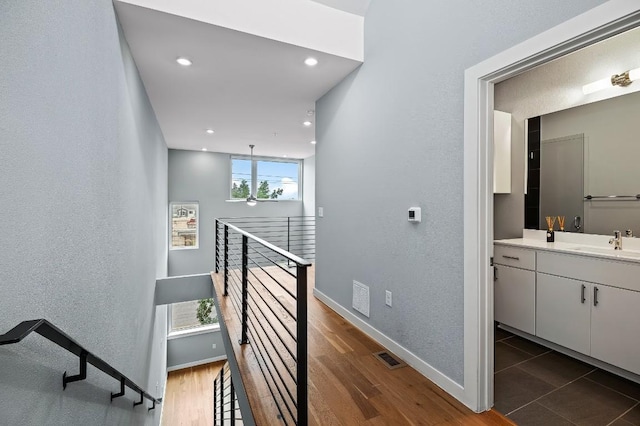 2002 E 7th St Unit 204, Austin, TX 78702 - stairs with baseboards, recessed lighting, and wood finished floors