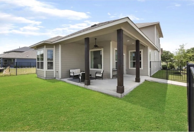 back of house with a yard, ceiling fan, and a patio area