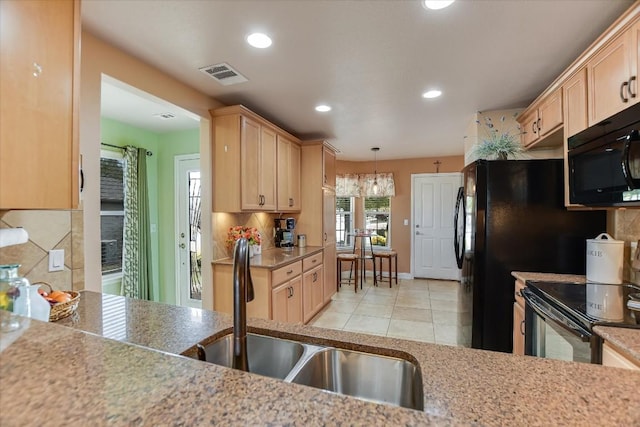 300 Sheldon Lake Dr, Georgetown, TX 78633 - kitchen with black appliances, a sink, light brown cabinets, and recessed lighting