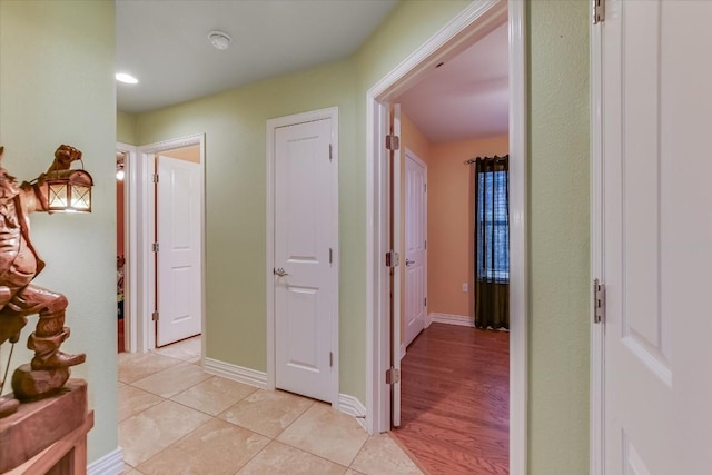 hall with light tile patterned floors