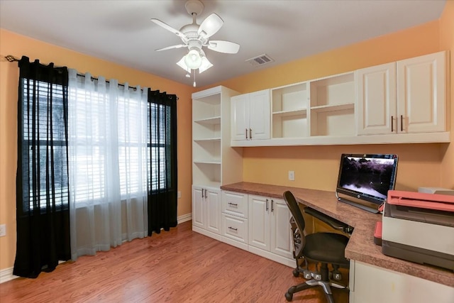 office with ceiling fan, light hardwood / wood-style floors, and built in desk