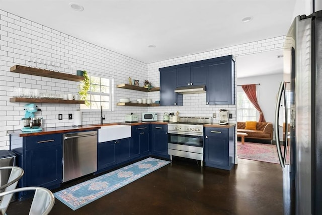 1508 E 11th St, Austin, TX 78702 - kitchen featuring butcher block counters, blue cabinets, stainless steel appliances, open shelves, and recessed lighting