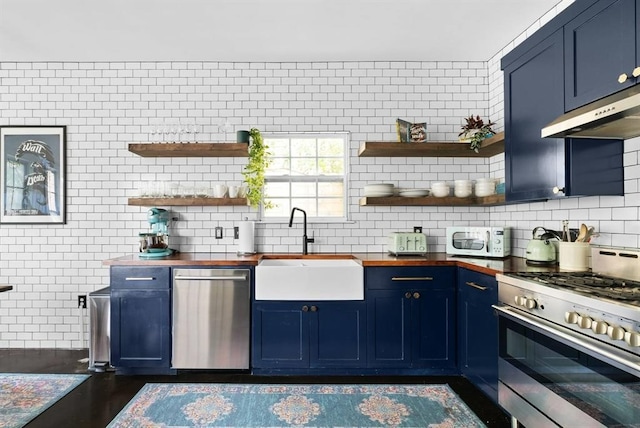 1508 E 11th St, Austin, TX 78702 - kitchen featuring wood counters, appliances with stainless steel finishes, blue cabinets, and open shelves