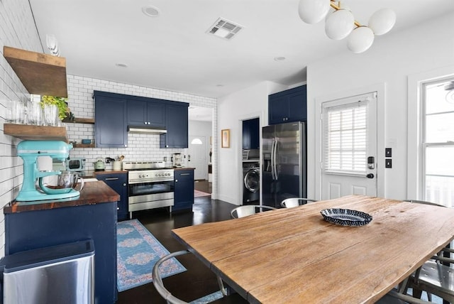 1508 E 11th St, Austin, TX 78702 - kitchen with appliances with stainless steel finishes, blue cabinets, open shelves, tasteful backsplash, and washer / dryer