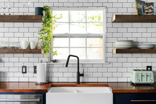 1508 E 11th St, Austin, TX 78702 - kitchen featuring wood counters, open shelves, dishwasher, and backsplash