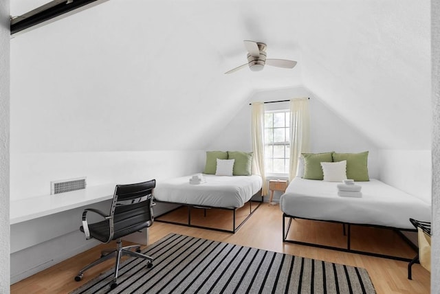 1508 E 11th St, Austin, TX 78702 - bedroom with wood finished floors, vaulted ceiling, a ceiling fan, and built in study area