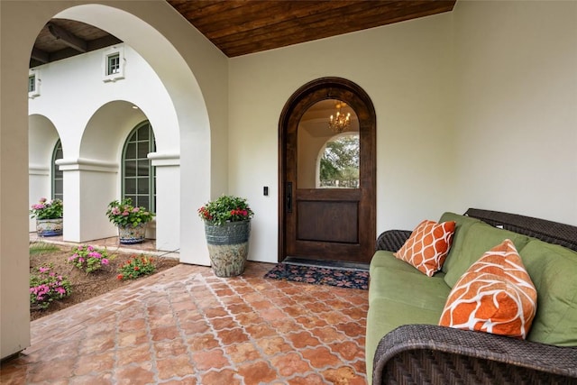 property entrance with a patio area and stucco siding