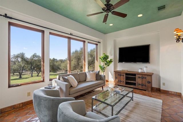 living room featuring visible vents, baseboards, recessed lighting, and a ceiling fan