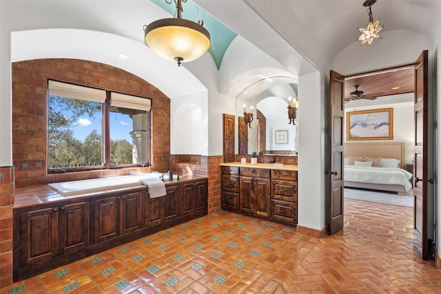 ensuite bathroom featuring vanity, a bath, a ceiling fan, and connected bathroom