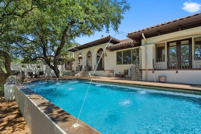 view of swimming pool featuring fence, a fenced in pool, and a patio