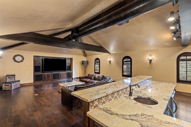 interior space with lofted ceiling with beams, baseboards, and dark wood finished floors