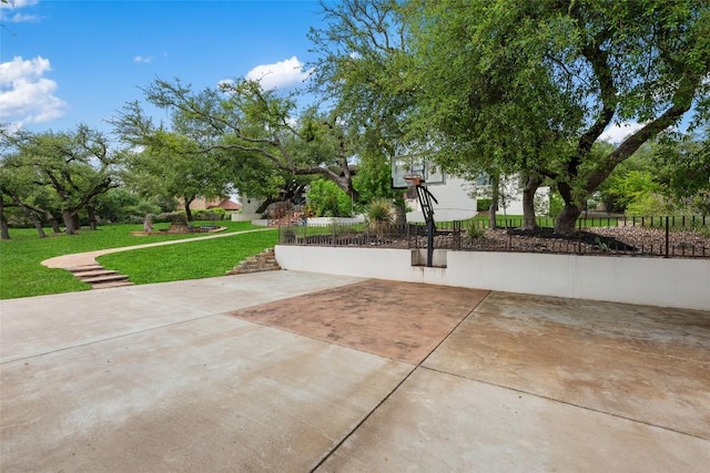 view of sport court with a yard, fence, and community basketball court