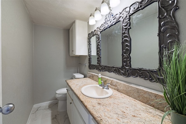 bathroom featuring toilet and vanity