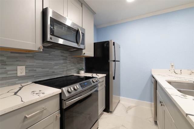 kitchen featuring light stone countertops, sink, appliances with stainless steel finishes, crown molding, and decorative backsplash