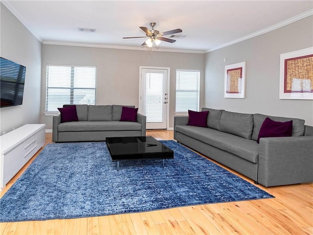 living room featuring hardwood / wood-style flooring, ornamental molding, and ceiling fan