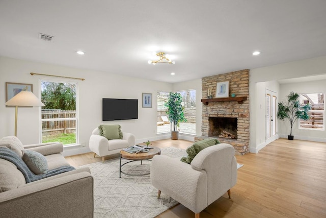 1907 Casa Grande Dr, Austin, TX 78733 - living room with healthy amount of natural light, a fireplace, light wood-style floors, and recessed lighting