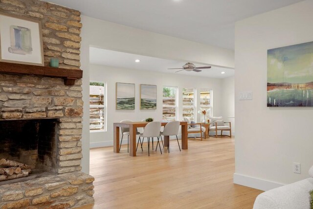 1907 Casa Grande Dr, Austin, TX 78733 - dining room with light wood-style flooring, recessed lighting, ceiling fan, and a stone fireplace