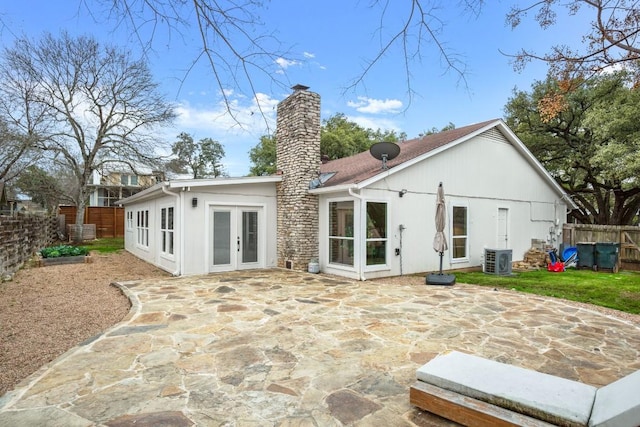 1907 Casa Grande Dr, Austin, TX 78733 - rear view of property featuring a chimney, french doors, a fenced backyard, and a patio area