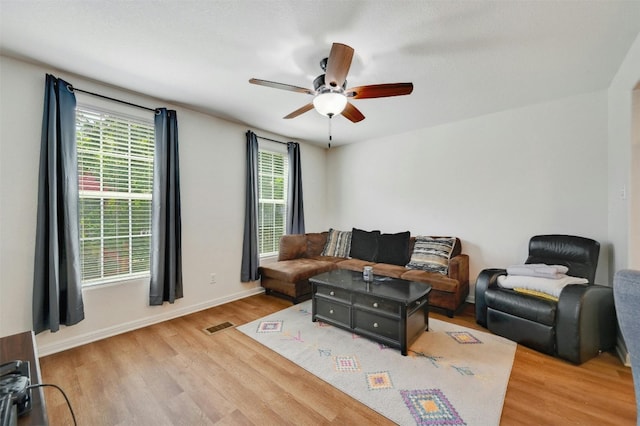 living room featuring hardwood / wood-style flooring and ceiling fan