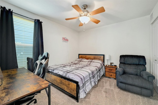 bedroom featuring light carpet and ceiling fan