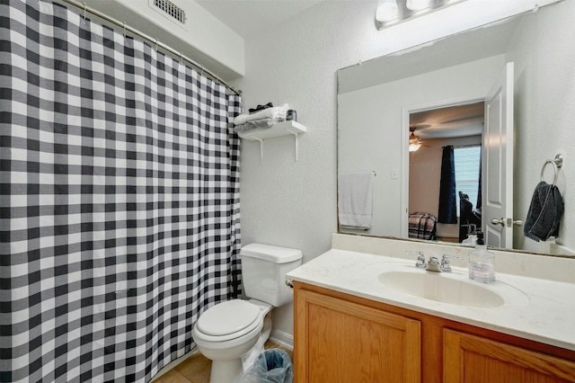 bathroom featuring tile patterned floors, toilet, and vanity