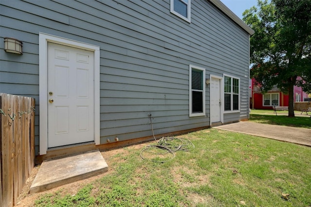 rear view of property with a lawn and a patio area