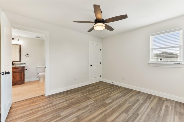 112 Callie St, Smithville, TX 78957 - unfurnished bedroom with ensuite bath, light wood-style flooring, visible vents, and baseboards