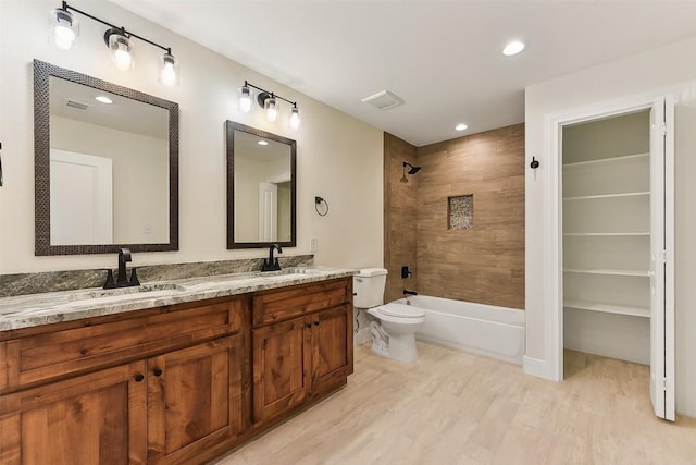 112 Callie St, Smithville, TX 78957 - bathroom with toilet, wood finished floors, a sink, and visible vents