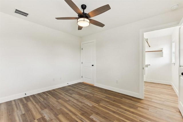 112 Callie St, Smithville, TX 78957 - unfurnished bedroom with wood finished floors, visible vents, baseboards, and ceiling fan