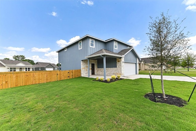 112 Callie St, Smithville, TX 78957 - view of front of home with fence, a front lawn, board and batten siding, driveway, and stone siding