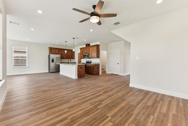 112 Callie St, Smithville, TX 78957 - unfurnished living room featuring baseboards, a ceiling fan, visible vents, and light wood-style floors