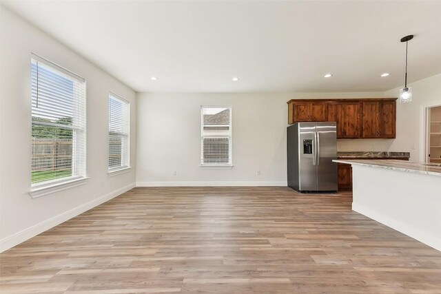 112 Callie St, Smithville, TX 78957 - kitchen with recessed lighting, stainless steel fridge, light wood-type flooring, and light countertops
