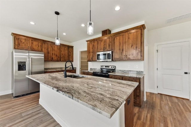 112 Callie St, Smithville, TX 78957 - kitchen featuring wood finished floors, visible vents, a sink, and appliances with stainless steel finishes
