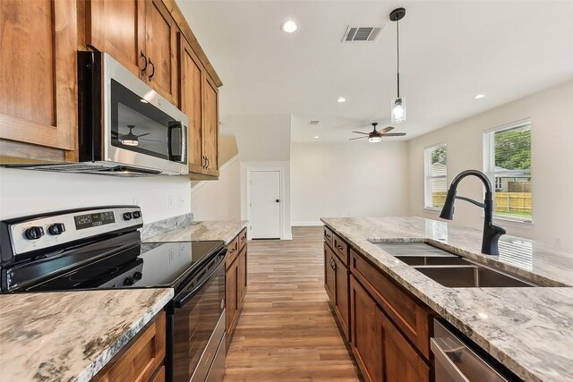 112 Callie St, Smithville, TX 78957 - kitchen with a sink, visible vents, recessed lighting, light wood-style floors, and appliances with stainless steel finishes