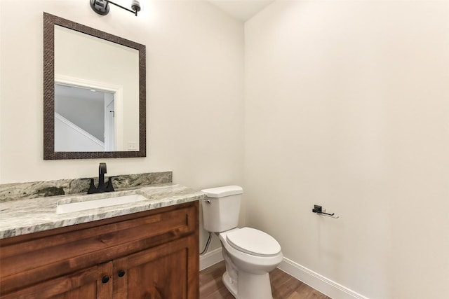 112 Callie St, Smithville, TX 78957 - bathroom with wood finished floors, vanity, toilet, and baseboards