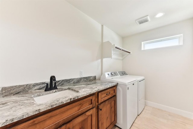 112 Callie St, Smithville, TX 78957 - clothes washing area featuring a sink, visible vents, baseboards, light wood-style floors, and washer and dryer