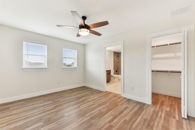 112 Callie St, Smithville, TX 78957 - unfurnished bedroom with a closet, a spacious closet, light wood-type flooring, baseboards, and visible vents